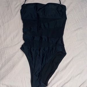 One-piece black bathing suit with mesh cutouts